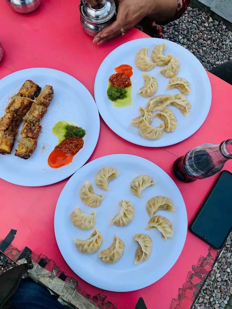 Plates of steamed momos with chutneys